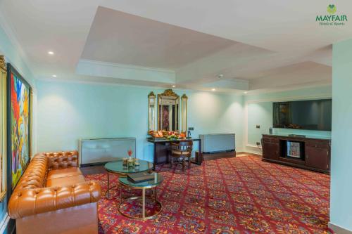 a living room with a couch and a table at Mayfair Spring Valley Resort Guwahati in Guwahati