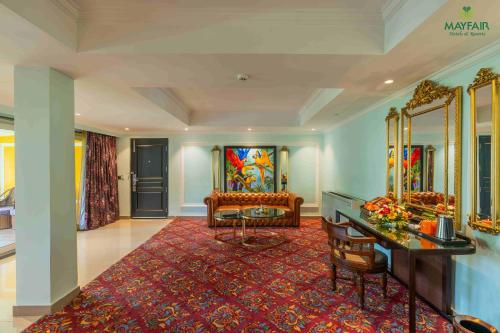 a room with a vanity and a dressing table and mirrors at Mayfair Spring Valley Resort Guwahati in Guwahati