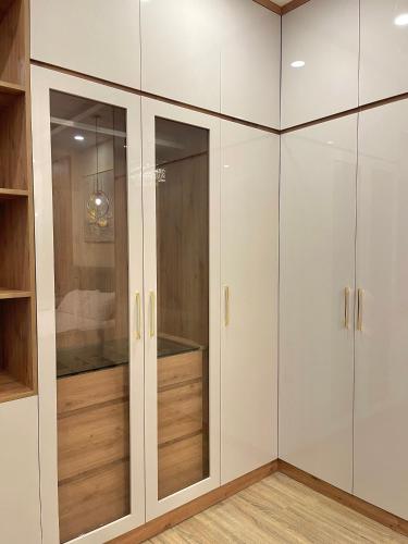 a walk in closet with white cabinets at Amazing Merit Ben Thanh in Ho Chi Minh City
