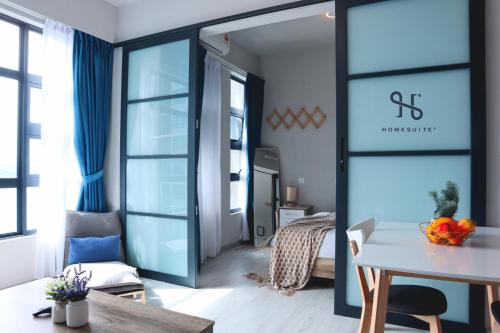 a living room with a table and a mirror at Homesuite' Home at Jesselton Quay in Kota Kinabalu