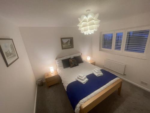 a bedroom with a bed with two towels on it at Riverside 2 Bedroom Townhouse with Car Charger in Abergavenny