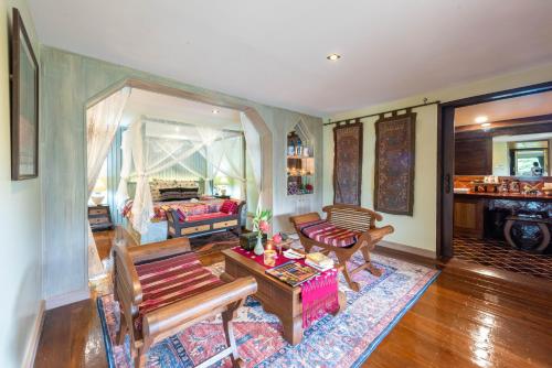 a living room with a couch and a table at Kanlaya's Eyrie, Luxury Homestay in Pang Mapha
