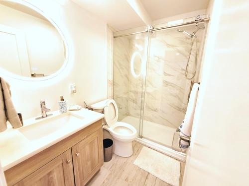 a bathroom with a shower and a toilet and a sink at Independent Studio Suite in Ottawa