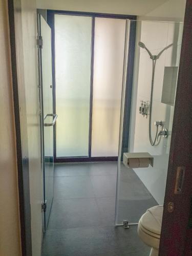 a bathroom with a glass shower with a toilet at Sand Dunes Chaolao Beach Resort in Chao Lao Beach