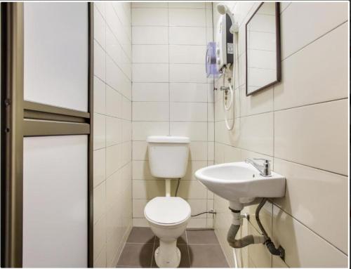 a bathroom with a toilet and a sink at NS INN Hotel in Melaka