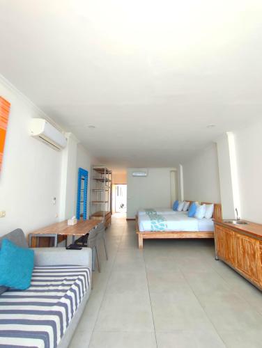 a living room with two beds and a table at Triple 8 Suites in Labuan Bajo
