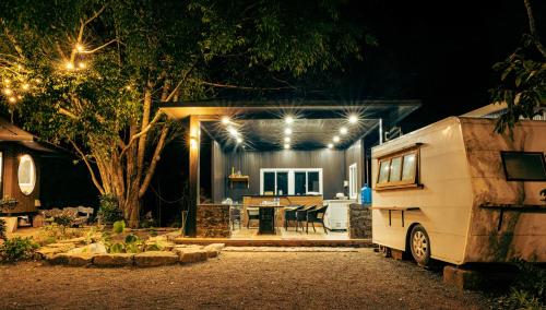 an rv parked in front of a house at night at Halo Retreat in Hòa Bình