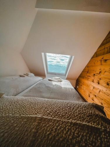 a room with two beds and a window at Hotel Bergsonne Rigi in Rigi Kaltbad