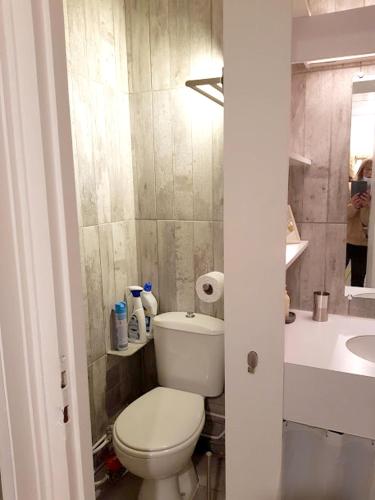 a bathroom with a white toilet and a sink at Studio avec vue sur la ville balcon et wifi a Vars in Vars