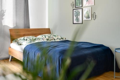 a bedroom with a bed with a blue blanket at Ruhige Oase in der Nähe von Parkanlage und Krankenhaus in Graz