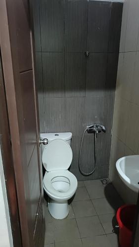 a small bathroom with a toilet and a sink at Rukost columbus in Karawang