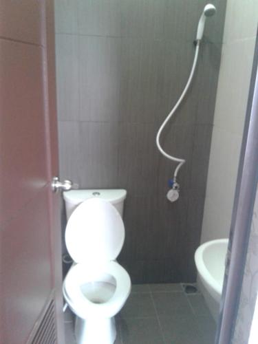 a bathroom with a toilet and a shower at Rukost columbus in Karawang