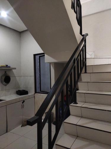 a staircase in a house with a stair case at Rukost columbus in Karawang