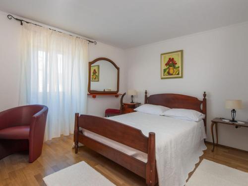 a bedroom with a bed and a chair and a mirror at Holiday Home in Barban with Private Pool in Barban