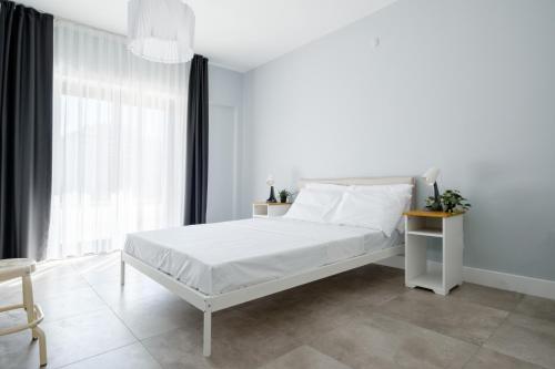a white bedroom with a white bed and a window at Luminous Flat 7 min to Arcadium Mall in Ankara in Ankara