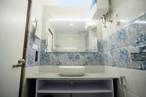 a bathroom with a sink and a mirror at Trideus Chandseena Valley Resort in Mussoorie