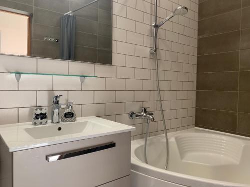 a bathroom with a sink and a shower and a tub at AquaGate Jurmala in Jūrmala