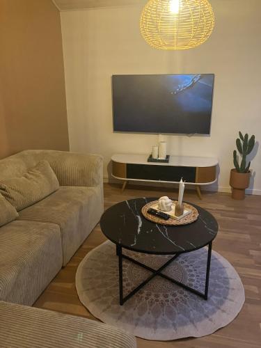 a living room with a couch and a table at 170 M2 stort hus tæt på centrum, MCH og Boxen in Herning