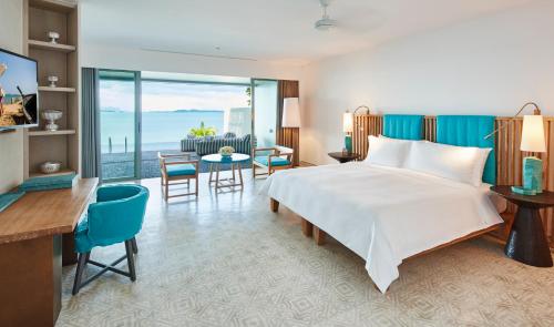 a hotel room with a bed and a living room at COMO Point Yamu, Phuket- SHA Extra Plus in Ban Pa Khlok