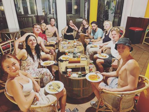 a group of people sitting in chairs eating food at Hummus Hostel & Restaurant in Hikkaduwa