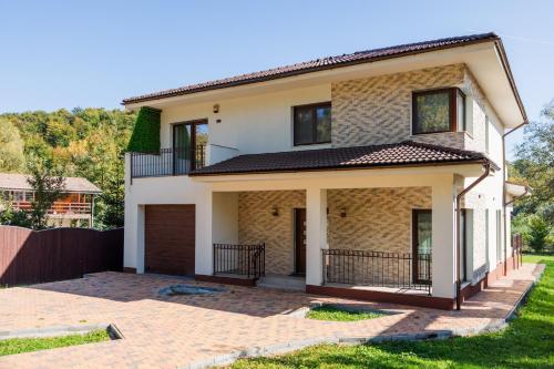 a house with a driveway in front of it at Villa Casablanca in Braşov