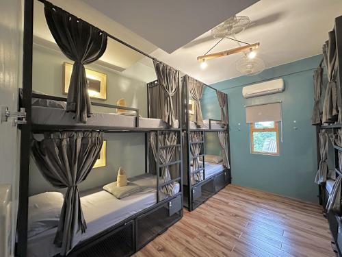 a room with two bunk beds in it at Outpost Hostel - Coron in Coron