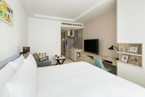 a bedroom with a bed and a living room at Hyatt House Tokyo Shibuya in Tokyo