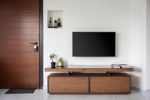 a living room with a television on a wall at Aniv Villa by the Sea in Kinion
