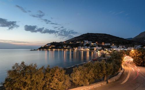 a town on the shore of a lake at night at Aniv Villa by the Sea in Kinion