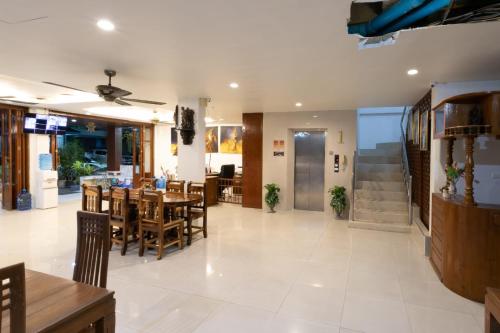 a dining room with a table and chairs at Best Venue Hotel in Patong Beach