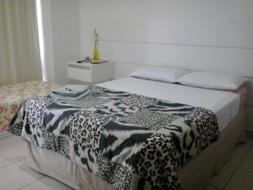 a bedroom with a black and white blanket on a bed at Flat BV Beira-Mar - Edf Beach Class EXECUTIVE Apart-Hotel 507 in Recife