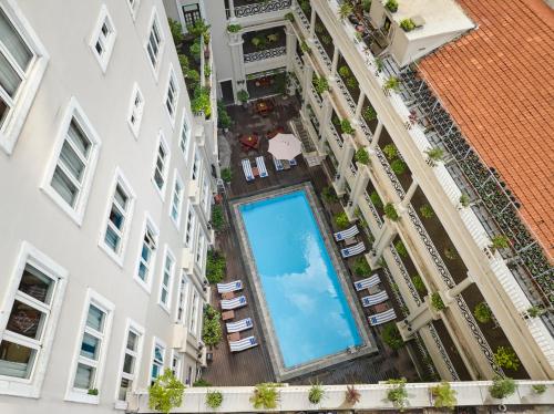 an overhead view of a swimming pool in a building at Hotel Grand Saigon in Ho Chi Minh City