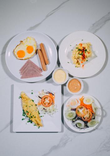 three plates of food on a table at Bouasavan Hotel and Garden in Savannakhet