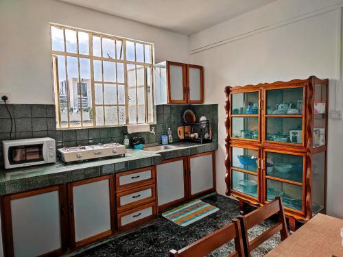 a kitchen with wooden cabinets and a counter top at Port Louis Centre penthouse in Port Louis