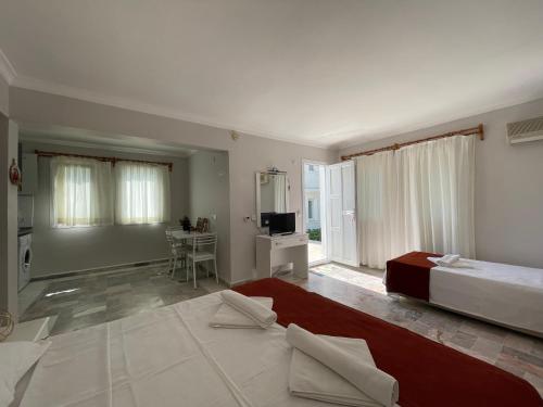 a bedroom with a bed and a living room at Sun Beach Villas in Foca