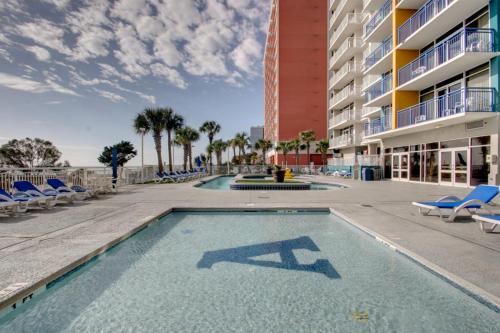 a swimming pool with chairs and a building at Oceanfront 1BR Condo, Your Coastal Escape at Atlantica in Myrtle Beach