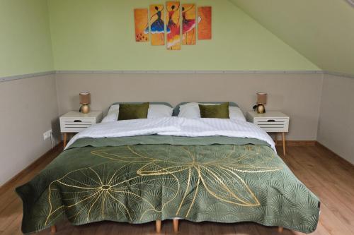 a bedroom with a large bed with two night stands at Boutique apartmán in Krompachy
