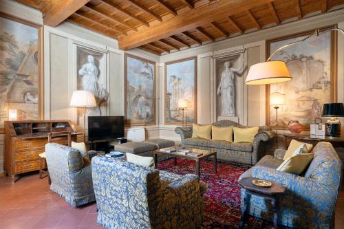 a living room with couches and a tv at Palazzo Antellesi in Florence