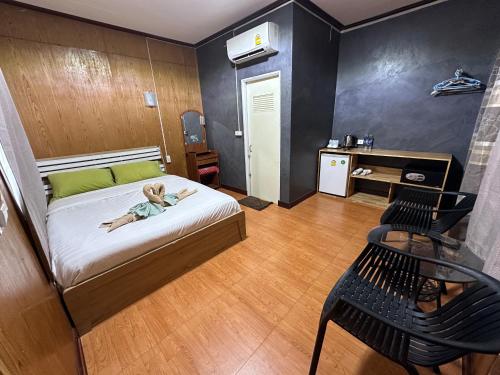 a small child laying on a bed in a room at Suan Nai Kokut Resort in Ko Kood