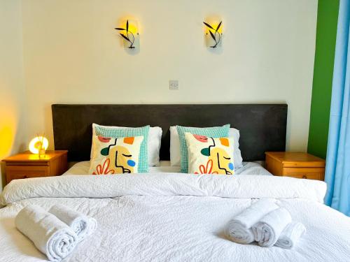a bedroom with two white towels on a bed at Seascape Bliss - Coastal Retreat in Youghal`s heart - Family Friendly - Long Term Price Cuts in Youghal