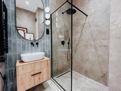 a bathroom with a sink and a shower at Paulay 11 Center Designer Apartment in Budapest