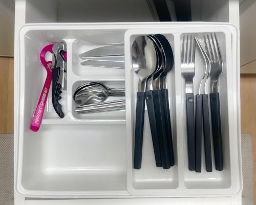 a white container filled with utensils and silverware at BlueMoon 2Bedroom 1Toilet in Seoul