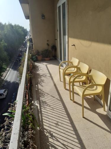 a row of chairs sitting on the balcony of a building at A casa di Adele in Caserta