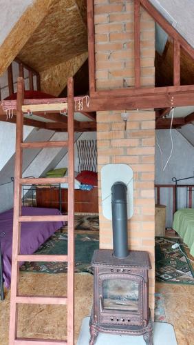 a bunk bed with a wood stove in a room at Kingu talu in Aiaste