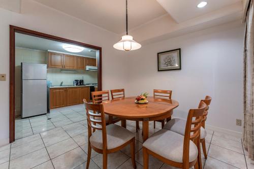 a kitchen and dining room with a wooden table and chairs at Garden View Court Suites Ho Chi Minh City in Ho Chi Minh City