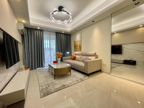 a living room with a couch and a chandelier at SKY 31 Luxurious Condominium in Phnom Penh