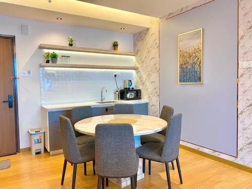 a kitchen with a table and chairs in a room at imperium residence kuantan in Kuantan
