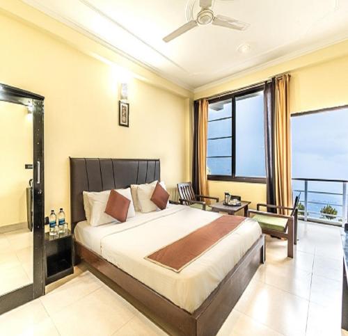a bedroom with a large bed and a balcony at Flutter Hotels & Resorts in Lansdowne