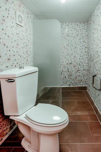 a bathroom with a white toilet in a room at Wadi Rum Desert Dunes Luxury Camp in Wadi Rum