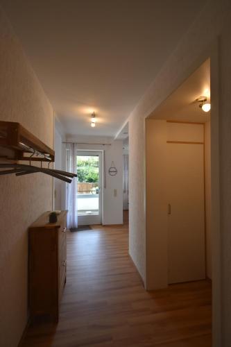 an empty living room with a hallway with a door at Wald & Weg in Schmallenberg